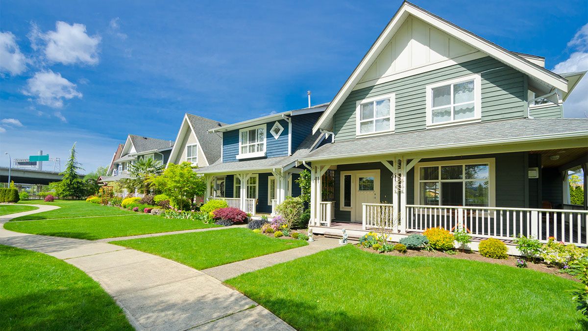 Photo of neighborhood and residential lawns with blue skies